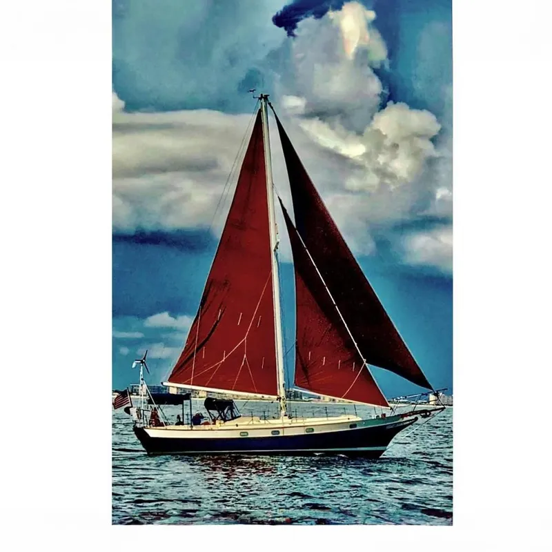 The Image of 1985 Kadey-Krogen 38 sailboat on open sea under dramatic sky. - 0