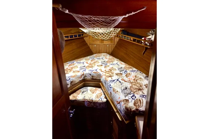 Slide: The Image of Cozy cabin interior of 1985 Kadey-Krogen 38 with nautical-themed bedding. - 10