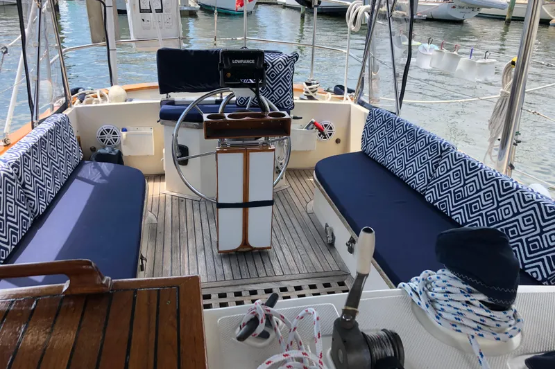 Slide: The Image of Cockpit of 1985 Kadey-Krogen 38 yacht with patterned cushions and nautical equipment. - 13