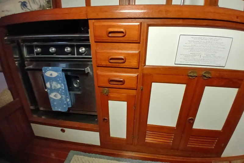Slide: The Image of 1985 Kadey-Krogen 38 yacht kitchen with wooden cabinetry and stainless steel stove. - 21