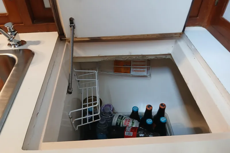 Slide: The Image of Built-in cooler with beverages on a 1985 Kadey-Krogen 38 boat. - 23