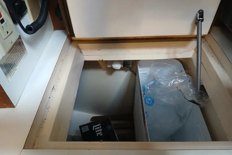 Slide: The Image of Storage compartment with ice bag in 1985 Kadey-Krogen 38 boat interior. - 24