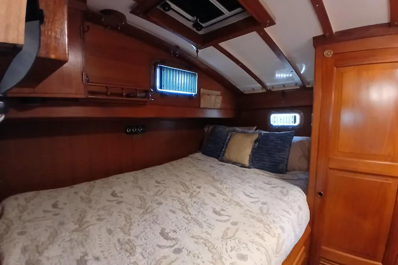 Slide: The Image of Cozy cabin interior of 1985 Kadey-Krogen 38 yacht with wooden finish and comfortable bedding. - 25