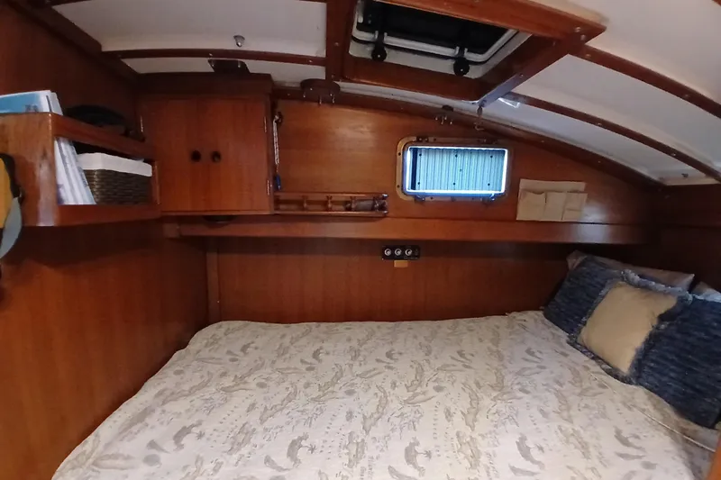 Slide: The Image of Cozy cabin interior of 1985 Kadey-Krogen 38 yacht with wooden finish and bedding. - 26