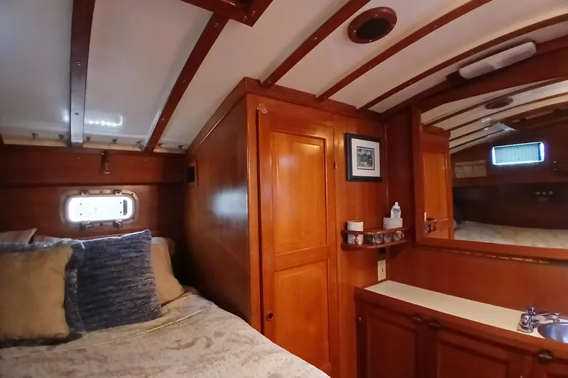 Slide: The Image of Cozy 1985 Kadey-Krogen 38 cabin interior with wood paneling and nautical decor. - 27