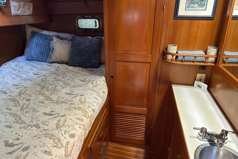 Slide: The Image of Cozy cabin interior of 1985 Kadey-Krogen 38 with bed, pillows, and wooden cabinetry. - 29