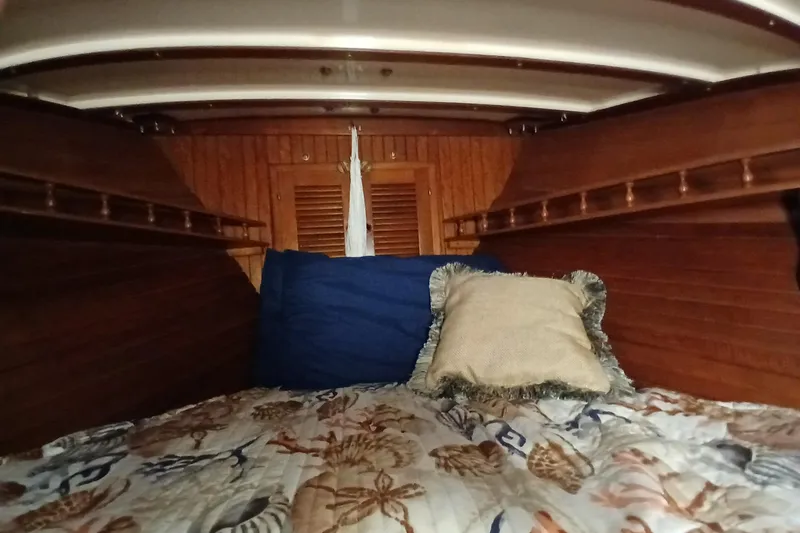 Slide: The Image of Cozy cabin interior of 1985 Kadey-Krogen 38 with wooden walls and decorative bedding. - 31