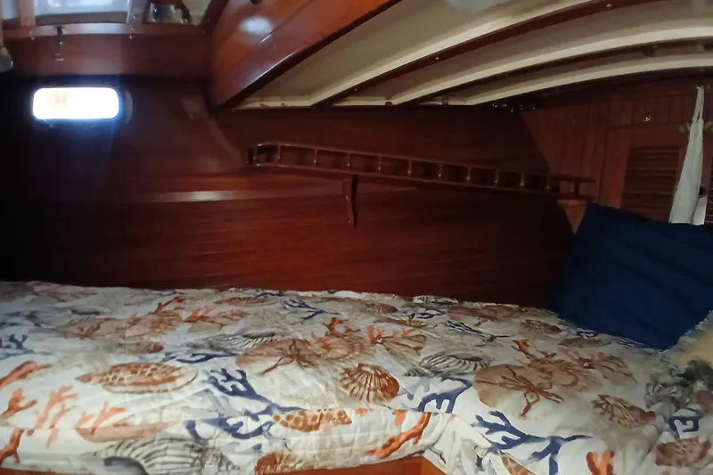 Slide: The Image of Cozy cabin interior of 1985 Kadey-Krogen 38 with nautical-themed bedding. - 32
