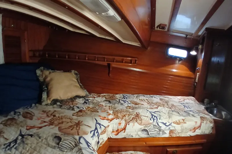 Slide: The Image of Cozy cabin interior of 1985 Kadey-Krogen 38 with nautical-themed bedding. - 34