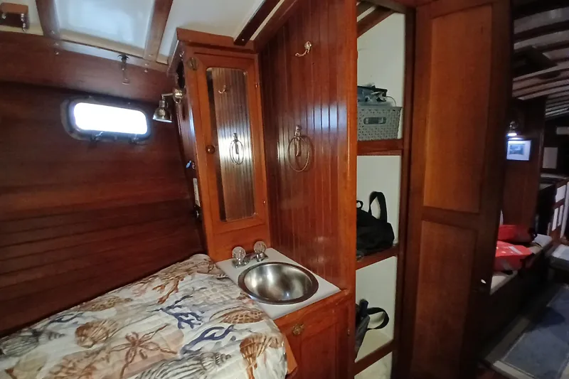 Slide: The Image of Cozy 1985 Kadey-Krogen 38 cabin interior with wood paneling and compact sink. - 35