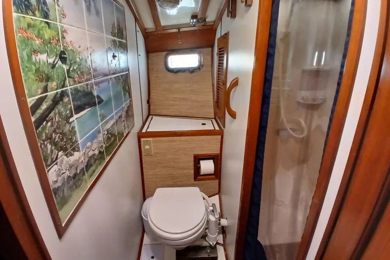 Slide: The Image of 1985 Kadey-Krogen 38 yacht bathroom with scenic tile mural and compact shower. - 36
