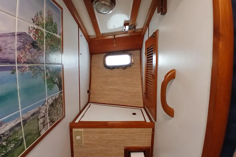 Slide: The Image of Interior of 1985 Kadey-Krogen 38 with nautical decor and wooden accents. - 38