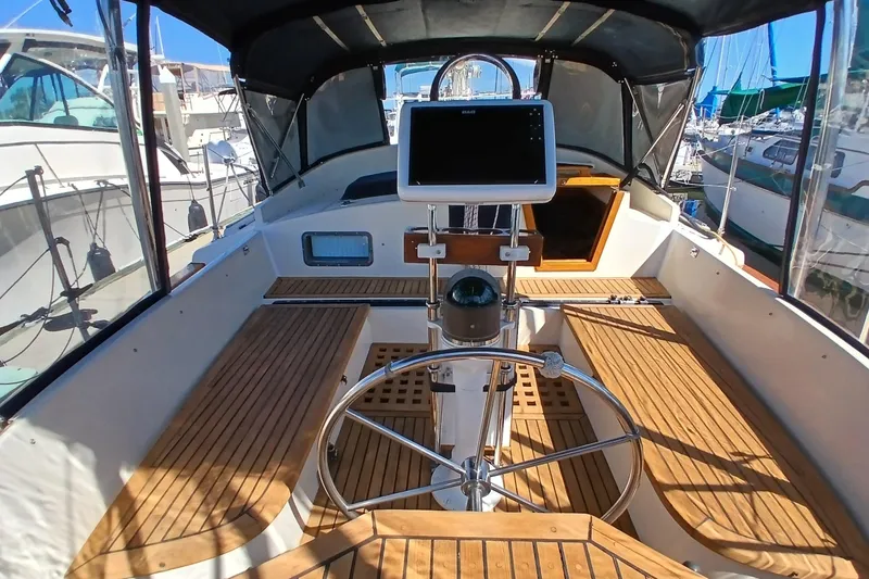 Slide: The Image of Cockpit of 1985 Kadey-Krogen 38 yacht with wooden seating and navigation equipment. - 41