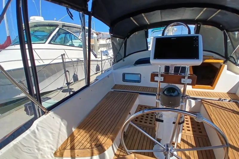 Slide: The Image of Cockpit of 1985 Kadey-Krogen 38 yacht with steering wheel and navigation equipment. - 42