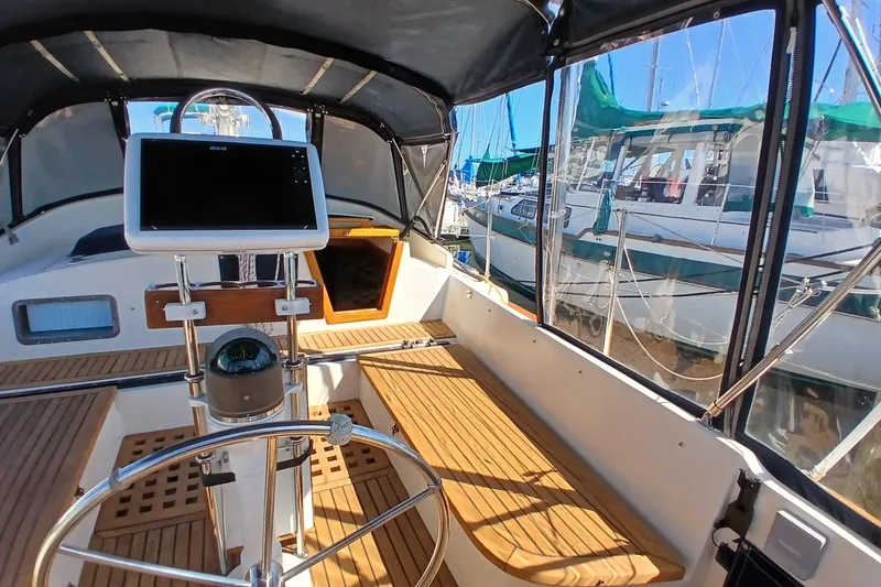 Slide: The Image of Cockpit of 1985 Kadey-Krogen 38 yacht with steering wheel and navigation equipment. - 43