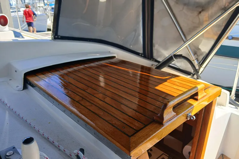 Slide: The Image of Polished wooden hatch on 1985 Kadey-Krogen 38 boat, docked at marina. - 45