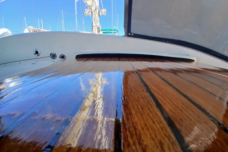 Slide: The Image of Polished wooden deck of a 1985 Kadey-Krogen 38 yacht under clear blue sky. - 46