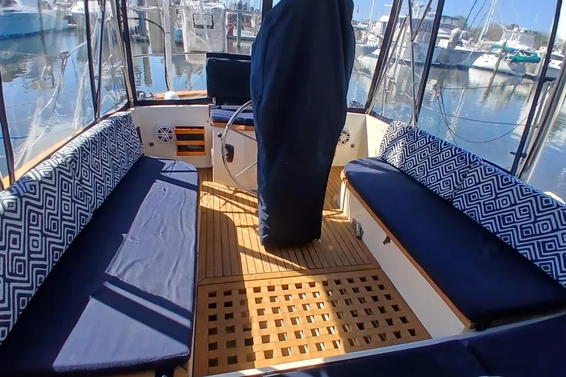 Slide: The Image of Interior of 1985 Kadey-Krogen 38 boat with cushioned seating and wooden flooring. - 47