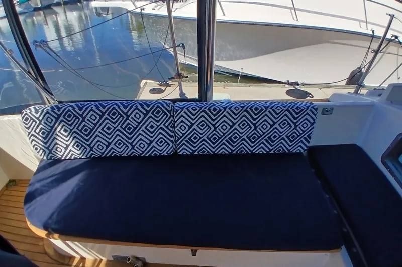 Slide: The Image of Cozy seating area on a 1985 Kadey-Krogen 38 boat with patterned cushions. - 48