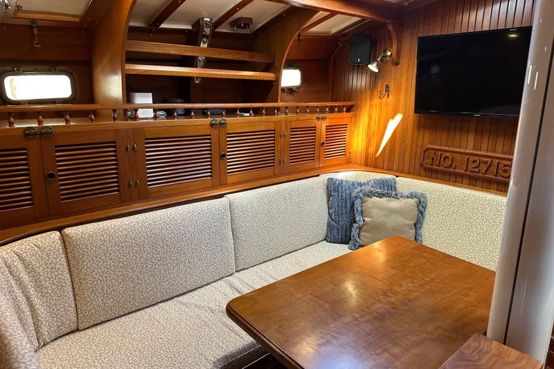 Slide: The Image of Luxurious 1985 Kadey-Krogen 38 yacht interior with elegant wood paneling and cozy seating area. - 5