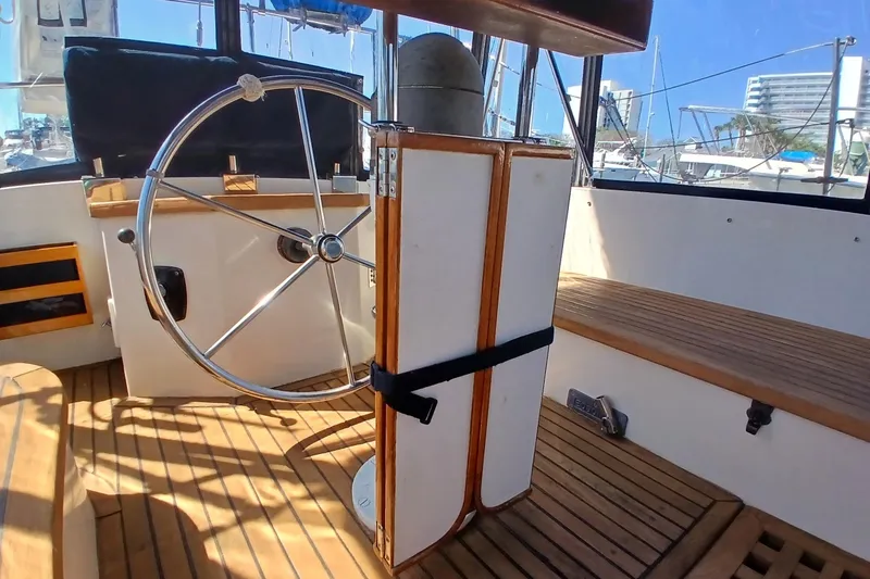 Slide: The Image of Interior view of 1985 Kadey-Krogen 38 yacht helm with wooden flooring and steering wheel. - 50
