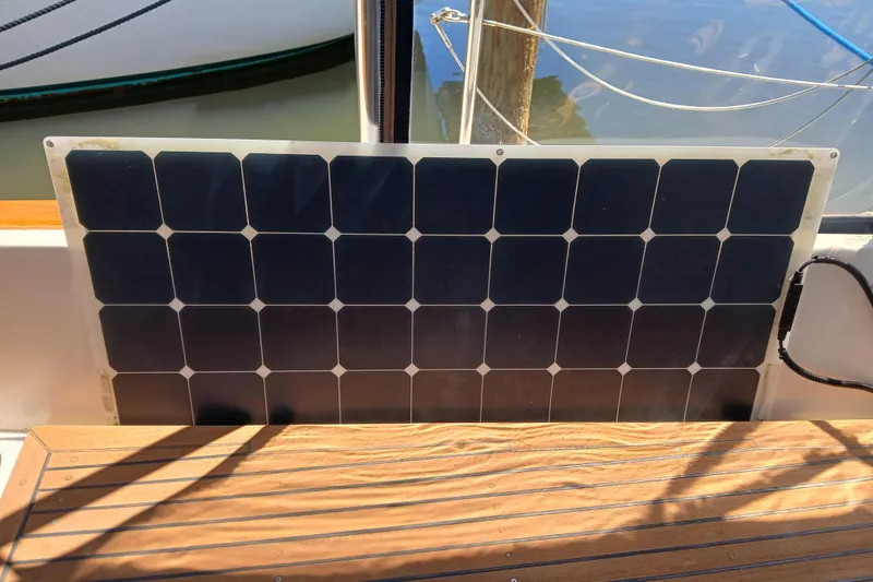 Slide: The Image of Solar panel on 1985 Kadey-Krogen 38 boat, mounted near wooden deck. - 56