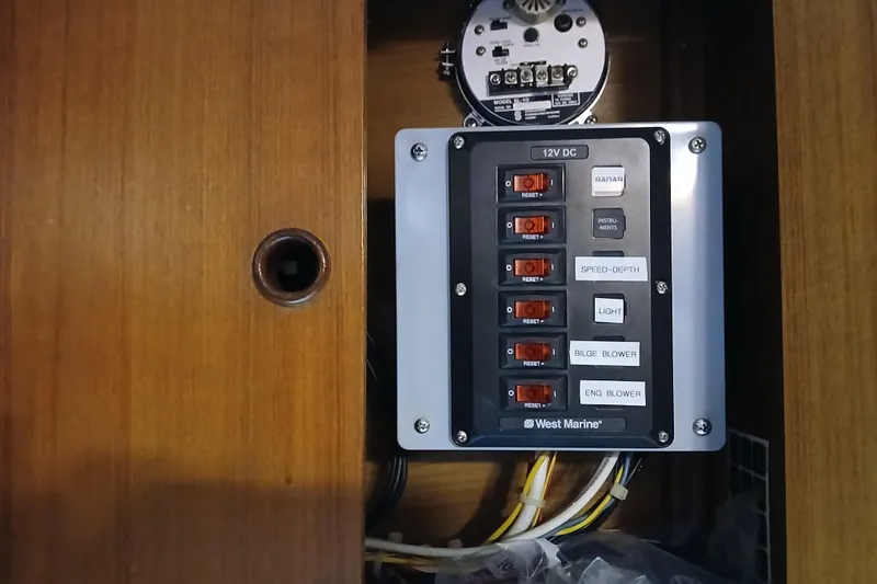 Slide: The Image of Electrical panel on 1985 Kadey-Krogen 38 boat with labeled switches and wiring. - 58