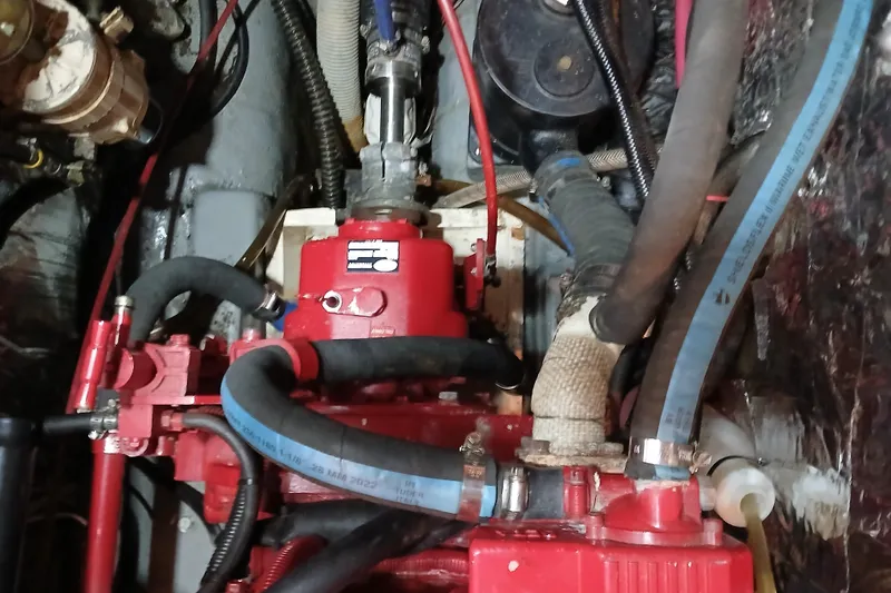 Slide: The Image of Engine compartment of a 1985 Kadey-Krogen 38 boat with visible hoses and components. - 59