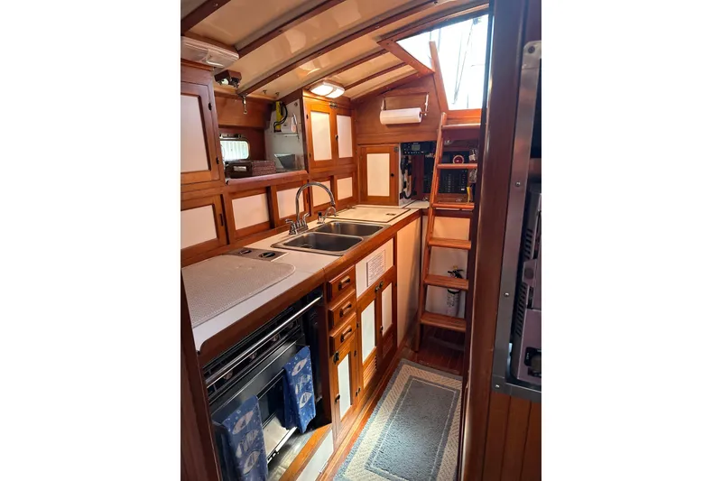 Slide: The Image of Interior of 1985 Kadey-Krogen 38 yacht featuring a wooden galley with sink and stove. - 6