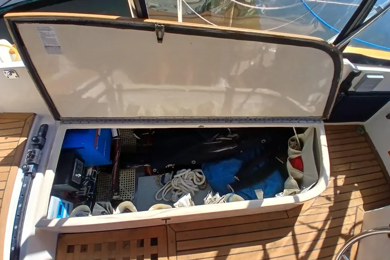 Slide: The Image of Open storage compartment on 1985 Kadey-Krogen 38 boat, showing ropes and equipment. - 63