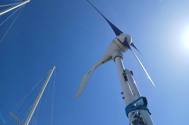Slide: The Image of Wind turbine on a 1985 Kadey-Krogen 38 sailboat against a clear blue sky. - 66