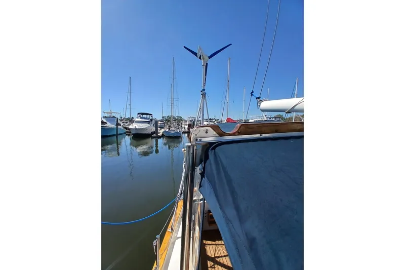 Slide: The Image of 1985 Kadey-Krogen 38 yacht docked in a marina under clear blue skies. - 67