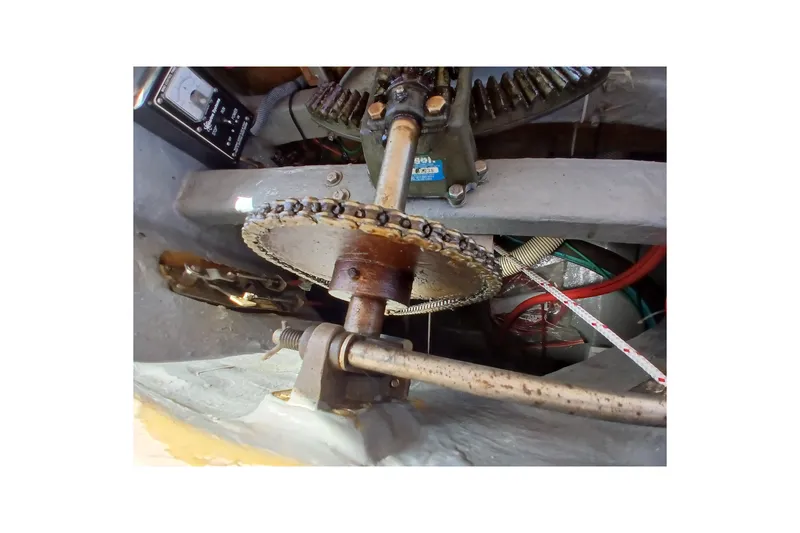 Slide: The Image of Mechanical components inside a 1985 Kadey-Krogen 38 boat, featuring gears and chains. - 69
