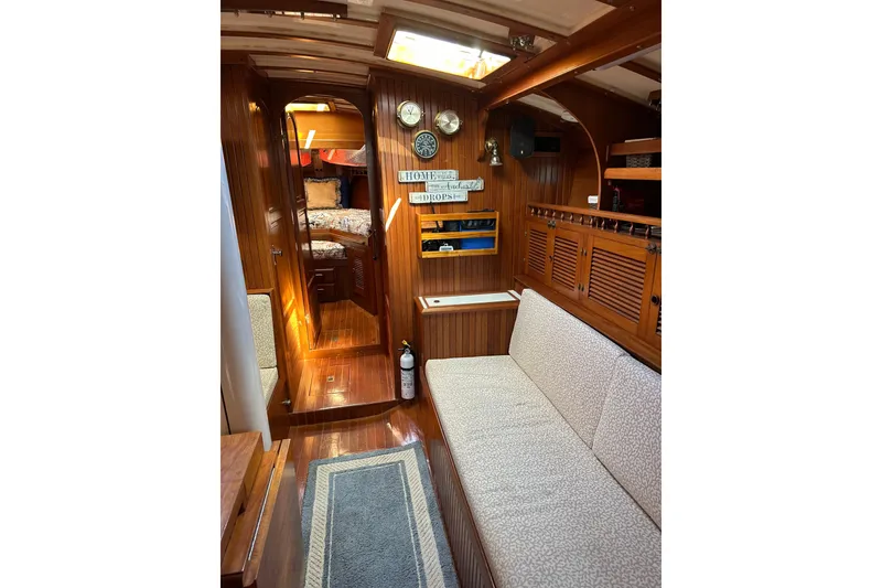 Slide: The Image of Interior of 1985 Kadey-Krogen 38 yacht with wood paneling and cozy seating area. - 7