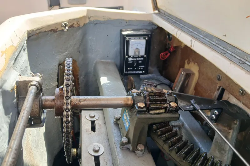 Slide: The Image of Mechanical components inside a 1985 Kadey-Krogen 38 boat, featuring gears and a control panel. - 71