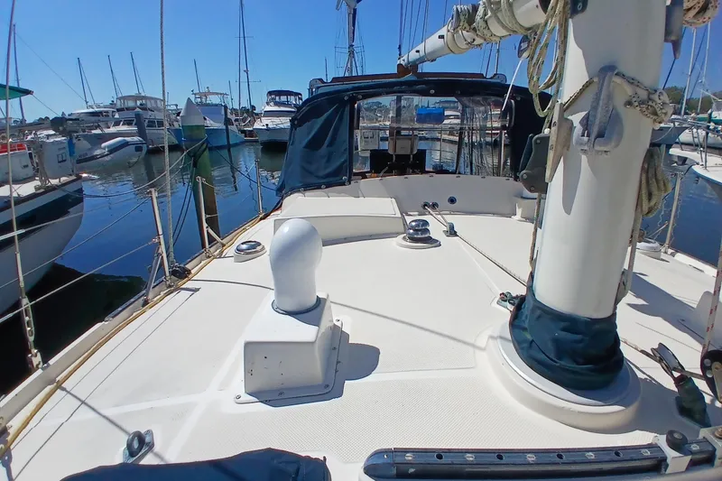 Slide: The Image of 1985 Kadey-Krogen 38 sailboat deck view in marina, surrounded by other boats. - 74