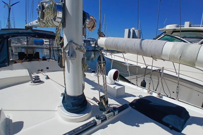 Slide: The Image of 1985 Kadey-Krogen 38 sailboat deck with rigging and marina view. - 76