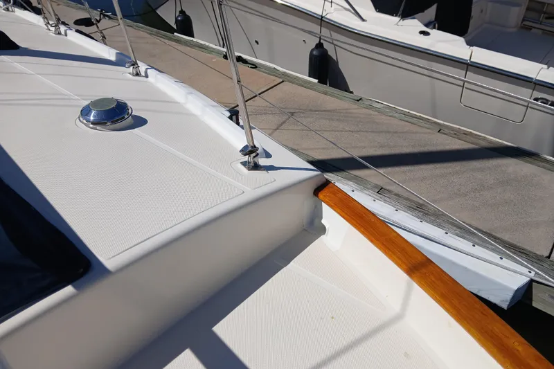 Slide: The Image of 1985 Kadey-Krogen 38 yacht deck with railing and docked boat in background. - 77