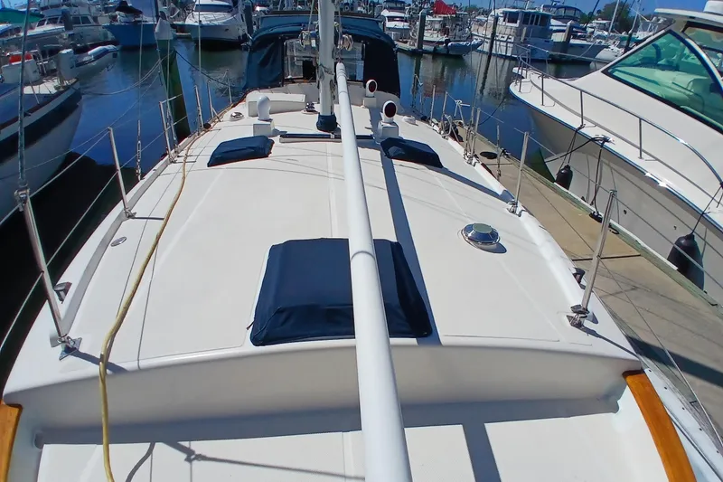 Slide: The Image of 1985 Kadey-Krogen 38 yacht docked at marina, showcasing spacious deck and sleek design. - 78