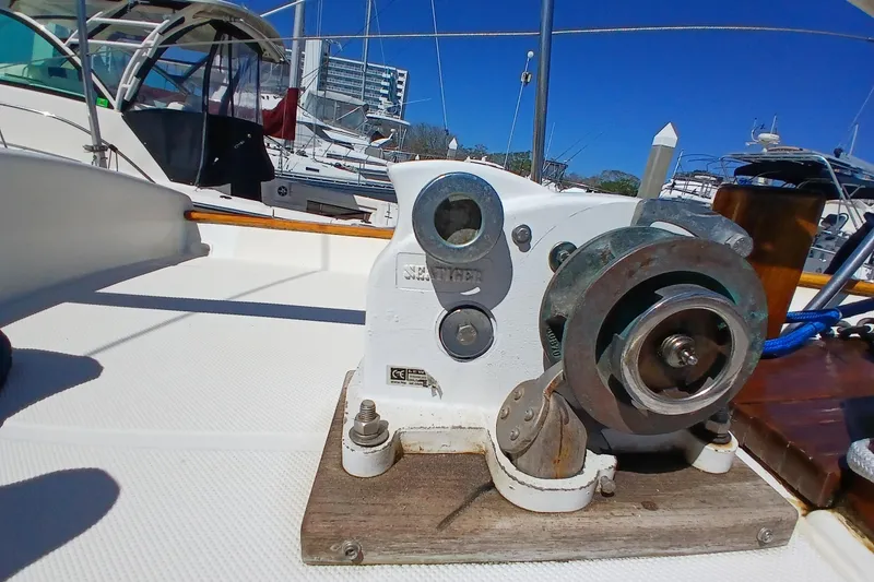 Slide: The Image of 1985 Kadey-Krogen 38 yacht deck with winch and marina background. - 79
