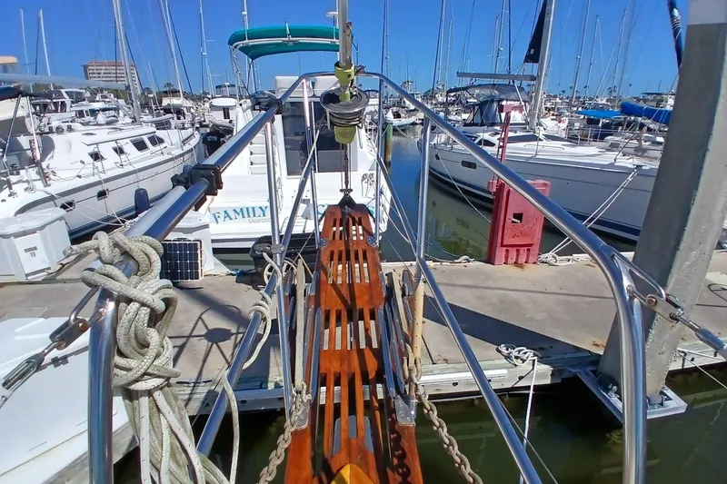 Slide: The Image of 1985 Kadey-Krogen 38 docked at marina, surrounded by sailboats. - 81