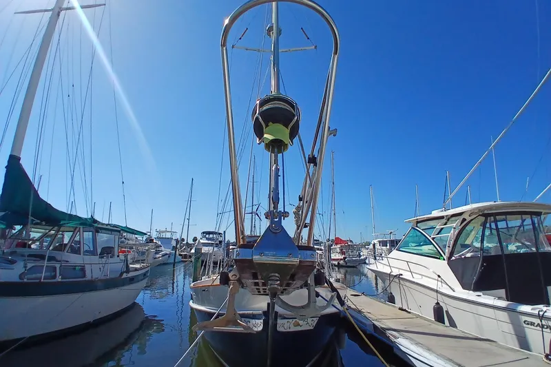 Slide: The Image of 1985 Kadey-Krogen 38 yacht docked in a sunny marina, surrounded by other boats. - 82