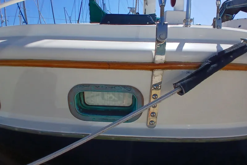 Slide: The Image of 1985 Kadey-Krogen 38 boat detail with porthole and railing. - 83