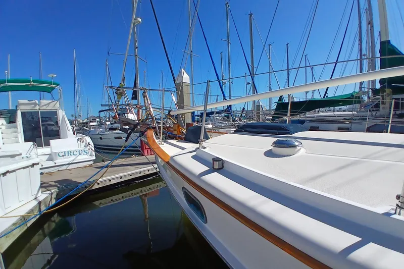 Slide: The Image of 1985 Kadey-Krogen 38 yacht docked in a marina, surrounded by other boats. - 84
