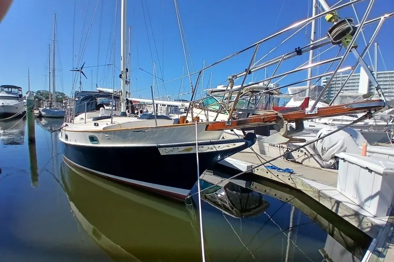 Slide: The Image of 1985 Kadey-Krogen 38 yacht docked at marina under clear blue sky. - 87