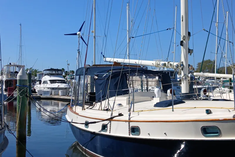 Slide: The Image of 1985 Kadey-Krogen 38 yacht docked at marina, surrounded by other boats under clear blue sky. - 89