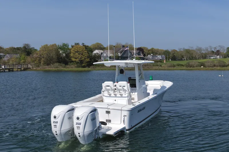 Slide: The Image of 2026 Regulator 28 boat with twin Yamaha 350 engines on a serene lake. - 10
