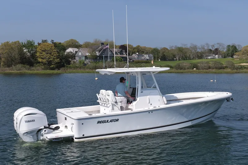 Slide: The Image of 2026 Regulator 28 boat with Yamaha engine cruising on a serene lake. - 11