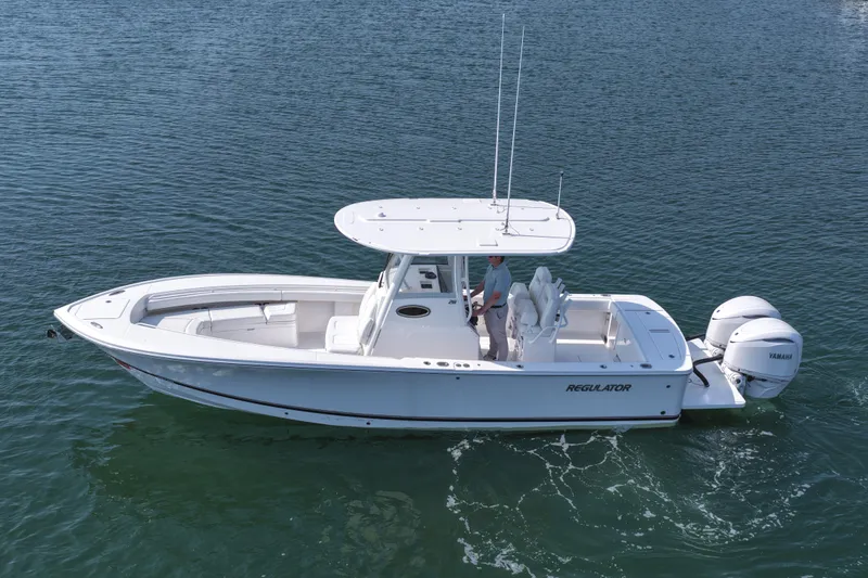Slide: The Image of 2026 Regulator 28 boat on water, featuring dual Yamaha engines and sleek design. - 13
