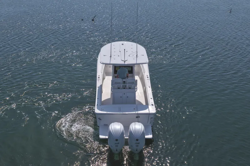 Slide: The Image of 2026 Regulator 28 boat with dual engines cruising on open water. - 14